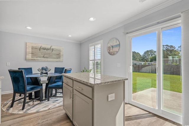 kitchen with recessed lighting, a center island, crown molding, and gray cabinetry
