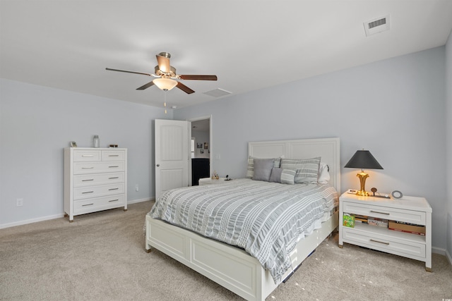bedroom with baseboards, ceiling fan, light carpet, and visible vents