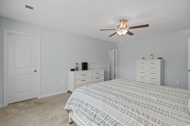 bedroom featuring light colored carpet, visible vents, baseboards, and a ceiling fan