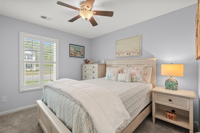 carpeted bedroom featuring visible vents, baseboards, and ceiling fan