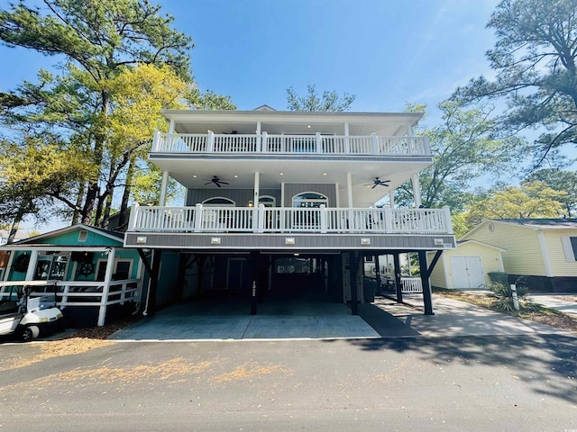 6001-1322 S Kings Hwy, Myrtle Beach, SC 29575 - view of front of property featuring ceiling fan, a carport, asphalt driveway, a balcony, and a wooden deck