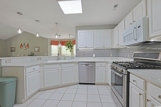 kitchen featuring a peninsula, visible vents, appliances with stainless steel finishes, and white cabinets