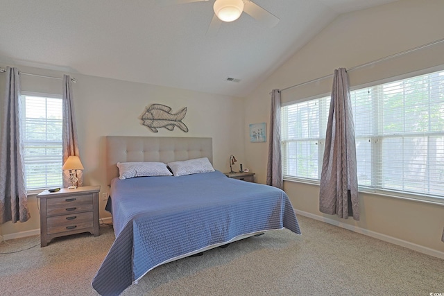 carpeted bedroom featuring visible vents, vaulted ceiling, baseboards, and ceiling fan