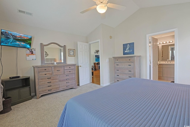 carpeted bedroom featuring lofted ceiling, ceiling fan, visible vents, a sink, and ensuite bathroom