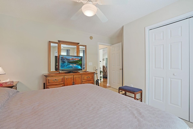 bedroom with ceiling fan and a closet