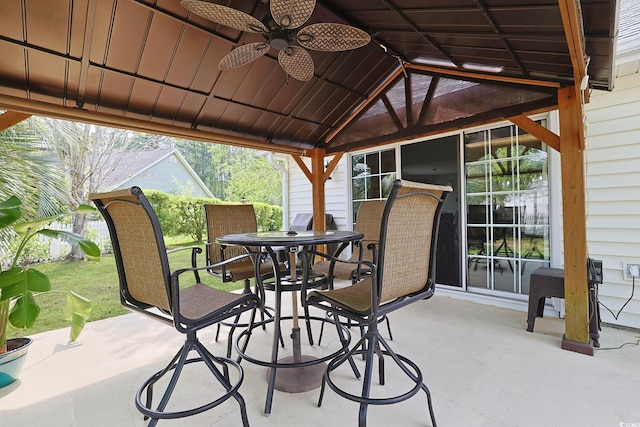 view of patio with a ceiling fan and outdoor dining space