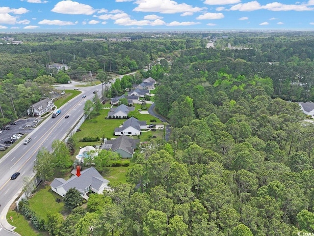 drone / aerial view with a forest view and a residential view