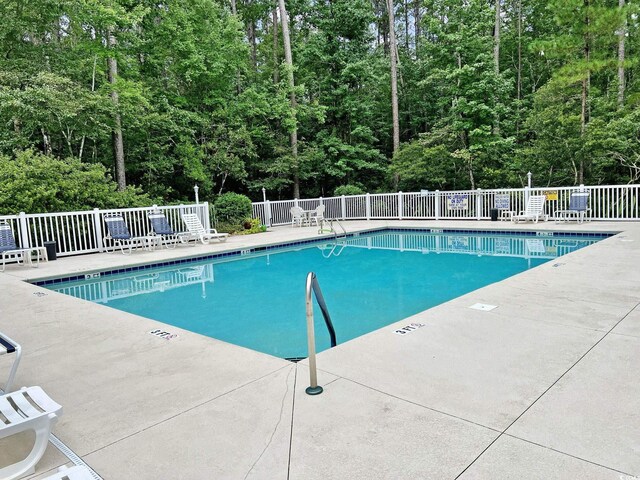 pool with fence and a patio area