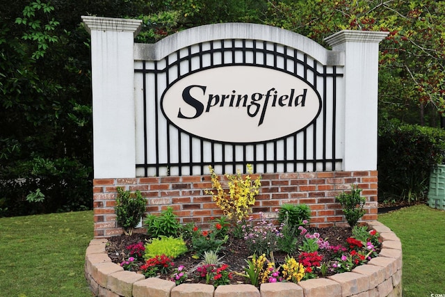 community / neighborhood sign featuring a lawn