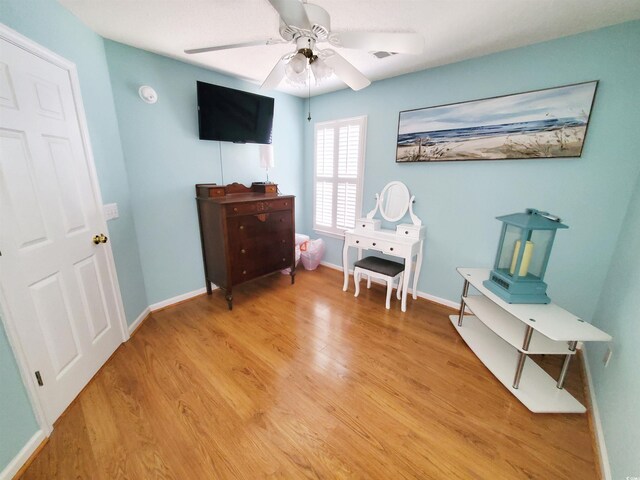 bedroom featuring baseboards, a ceiling fan, and light wood-type flooring