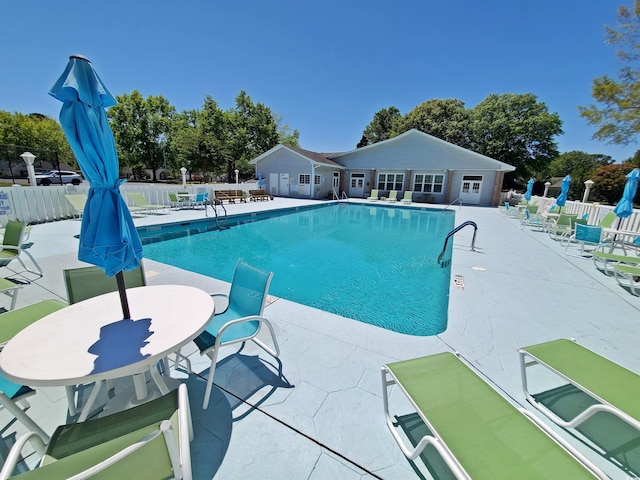 pool featuring a patio area and fence