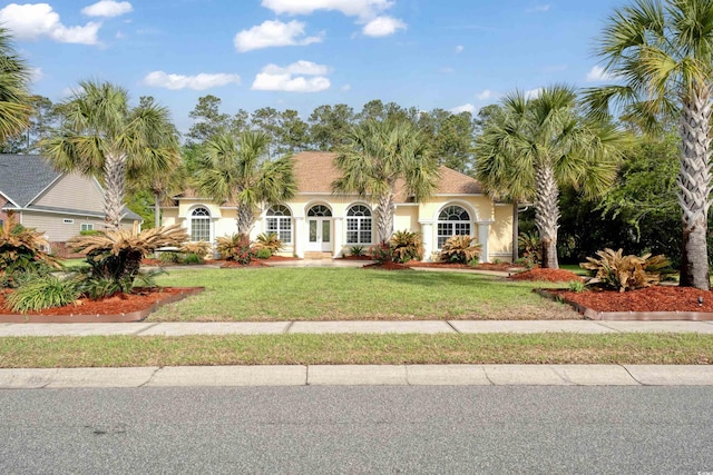 mediterranean / spanish-style house with stucco siding and a front lawn