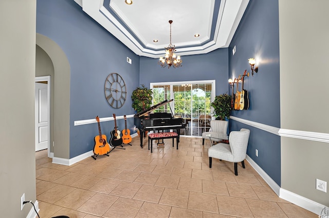 sitting room with a tray ceiling, baseboards, an inviting chandelier, light tile patterned flooring, and arched walkways