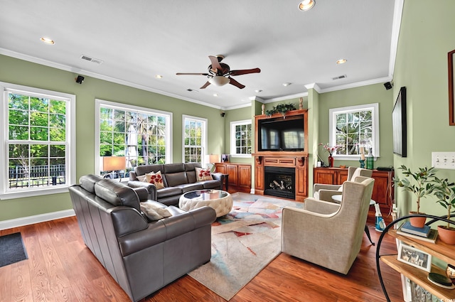 living room featuring a wealth of natural light, visible vents, a ceiling fan, and recessed lighting