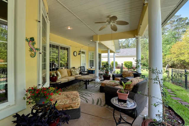 view of patio / terrace featuring fence, ceiling fan, and an outdoor living space