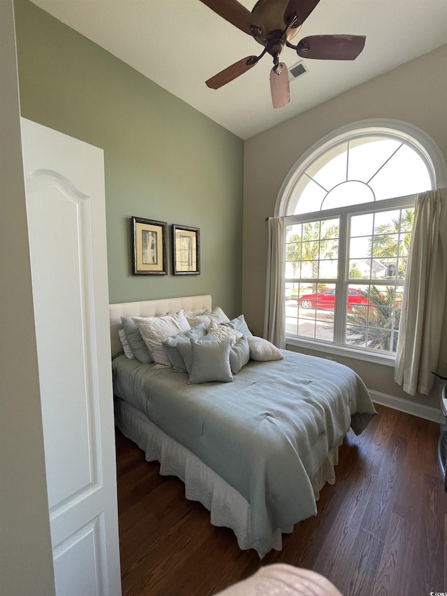 bedroom featuring visible vents, wood finished floors, ceiling fan, and multiple windows
