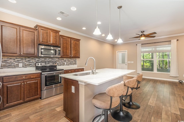 177 Olde Towne Way Unit 4, Myrtle Beach, SC 29588 - kitchen featuring stainless steel appliances, a kitchen breakfast bar, a sink, visible vents, and ceiling fan