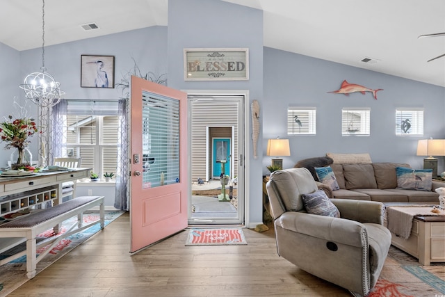 328 Logan St, Little River, SC 29566 - living area featuring a notable chandelier, visible vents, vaulted ceiling, and wood finished floors