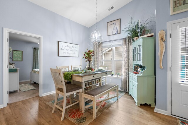 328 Logan St, Little River, SC 29566 - dining area with an inviting chandelier, visible vents, lofted ceiling, and light wood-type flooring