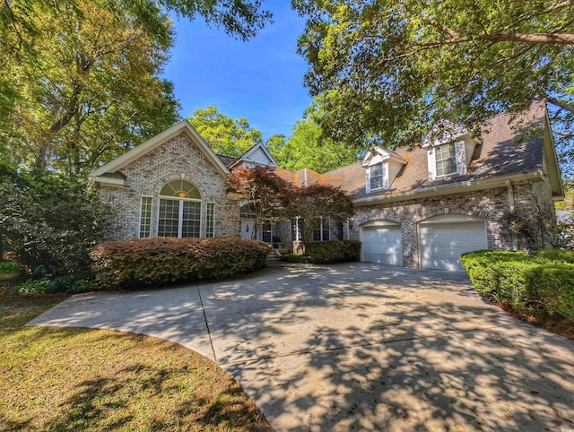 710 Masters Dr, Pawleys Island, SC 29585 - view of front of house with a garage, driveway, and brick siding