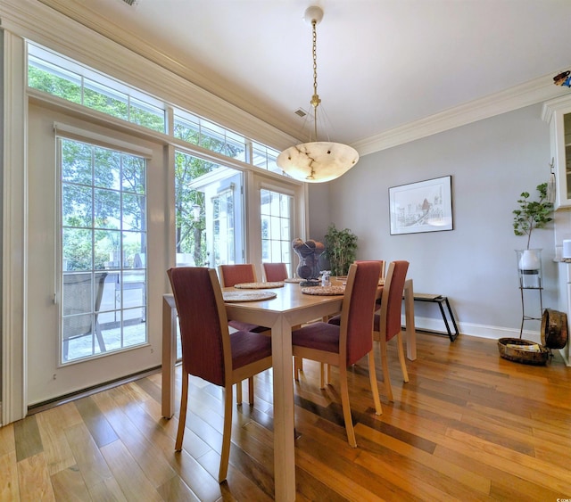 710 Masters Dr, Pawleys Island, SC 29585 - dining space featuring baseboards, a wealth of natural light, light wood-style floors, and crown molding