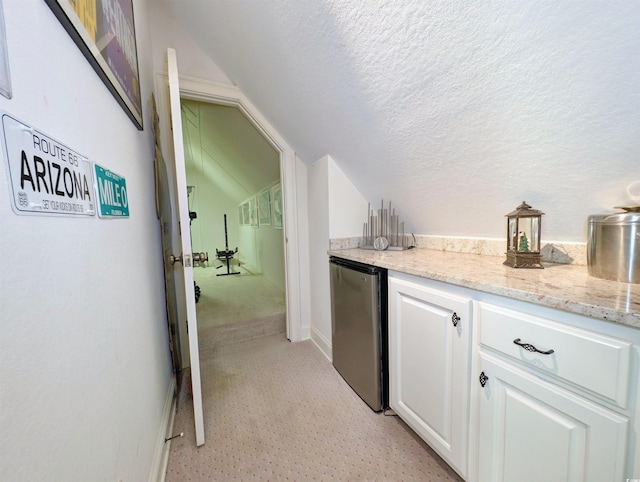 710 Masters Dr, Pawleys Island, SC 29585 - bar featuring a textured ceiling, fridge, vaulted ceiling, baseboards, and light colored carpet