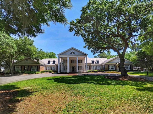 710 Masters Dr, Pawleys Island, SC 29585 - neoclassical home featuring a front lawn and covered porch