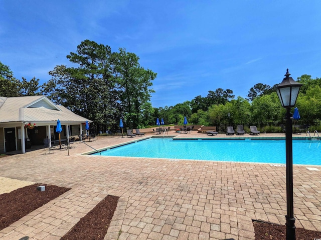 710 Masters Dr, Pawleys Island, SC 29585 - community pool with fence and a patio area