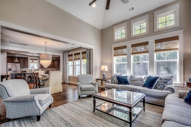 4964 Salt Creek Ct, North Myrtle Beach, SC 29582 - living area with dark wood-style flooring, ceiling fan, a towering ceiling, and a chandelier