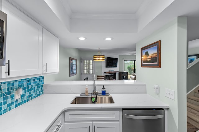 kitchen with recessed lighting, white cabinets, ornamental molding, dishwasher, and a sink