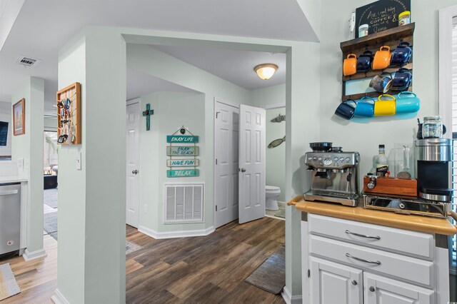 interior space featuring wood finished floors, visible vents, and baseboards