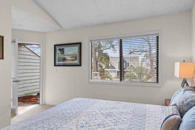 carpeted bedroom featuring vaulted ceiling and baseboards