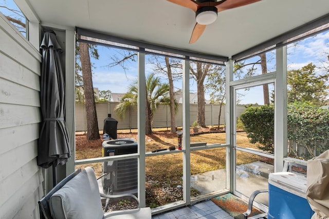 sunroom / solarium featuring ceiling fan and plenty of natural light