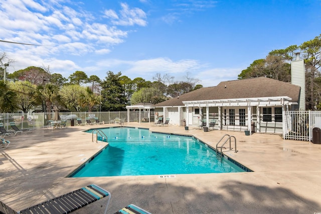pool featuring fence, a patio, a pergola, and french doors
