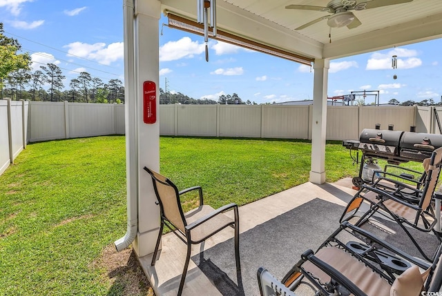 view of patio with a fenced backyard and a ceiling fan