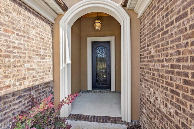 view of exterior entry with brick siding