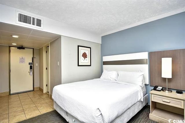 7100 N Ocean Blvd Unit 405, Myrtle Beach, SC 29572 - tiled bedroom featuring a textured ceiling and baseboards