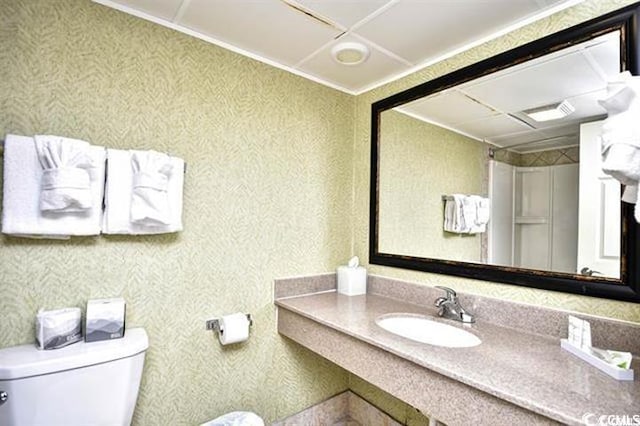 7100 N Ocean Blvd Unit 405, Myrtle Beach, SC 29572 - bathroom featuring toilet, vanity, and ornamental molding