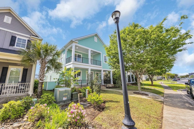 868 Crystal Water Way, Myrtle Beach, SC 29579 - view of front of property with covered porch, a balcony, and a front yard