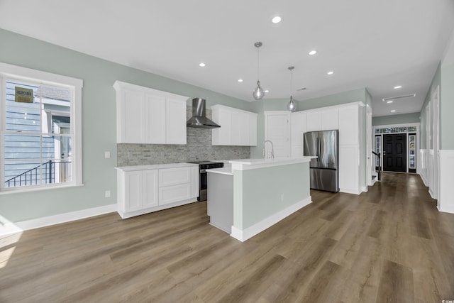 868 Crystal Water Way, Myrtle Beach, SC 29579 - kitchen featuring appliances with stainless steel finishes, wall chimney range hood, light countertops, backsplash, and white cabinetry