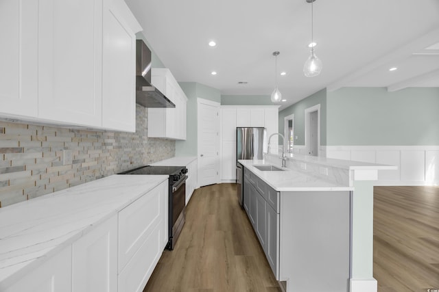 868 Crystal Water Way, Myrtle Beach, SC 29579 - kitchen with stainless steel appliances, wall chimney exhaust hood, light wood finished floors, light stone countertops, and recessed lighting