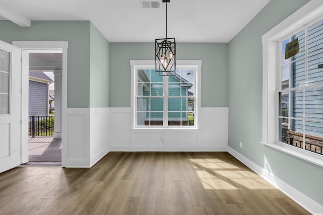 868 Crystal Water Way, Myrtle Beach, SC 29579 - unfurnished dining area with wood finished floors, a wainscoted wall, and a chandelier
