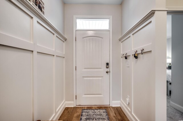 entryway with wood finished floors and baseboards