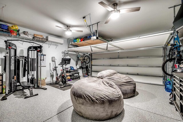 garage with a wall unit AC, ceiling fan, and a garage door opener