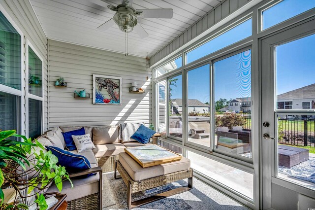sunroom featuring a ceiling fan and an outdoor hangout area