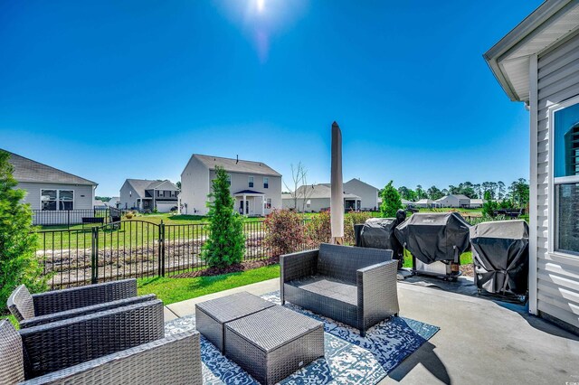 view of patio / terrace featuring a residential view, outdoor lounge area, fence, and a grill