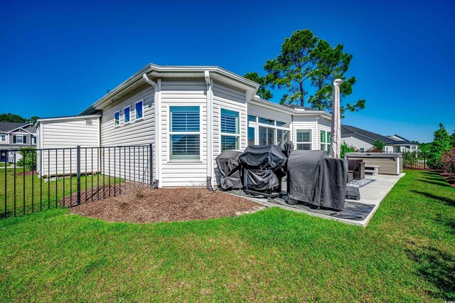 back of property with a hot tub