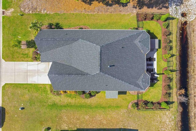 view of front of home with concrete driveway, a garage, and a front lawn