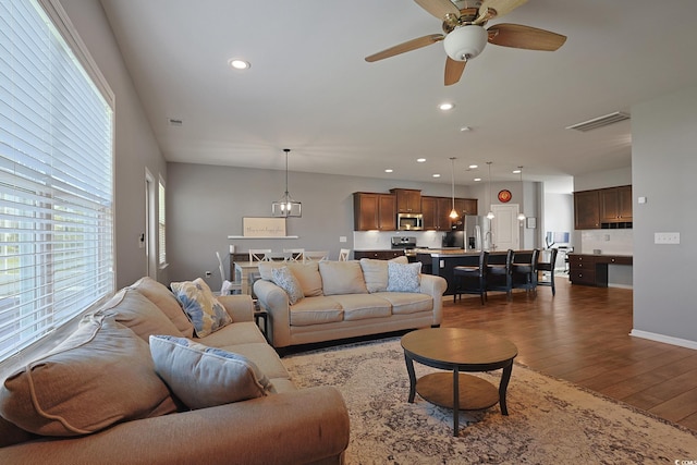 living room with recessed lighting, ceiling fan, dark wood finished floors, and visible vents