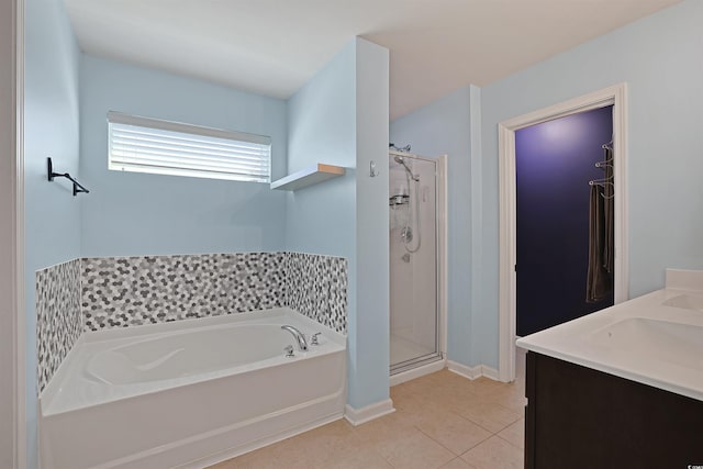 full bath featuring baseboards, tile patterned flooring, a shower stall, and a garden tub